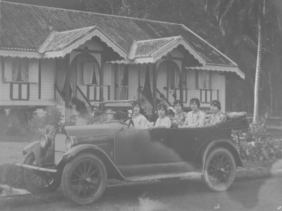 Motor car with female driver and passengers, 1920s